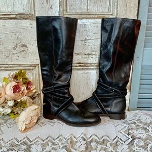 Tall black leather riding boots